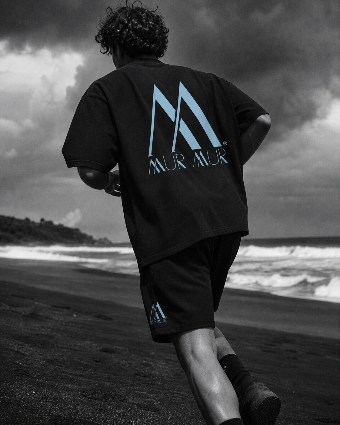 Model wearing the Mur Mur oversized boxy tee and heavyweight fleece shorts on the coast